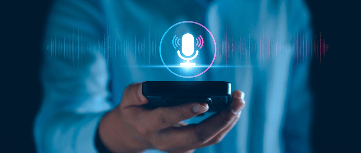 Person holding cell phone with microphone icon above it