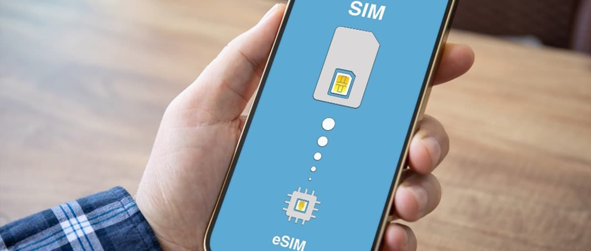 Man holding cell phone with eSIM display